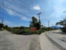 Road intersection with power lines and greenery