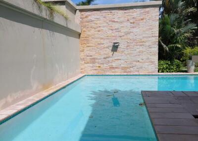 Private pool with surrounding deck and wall