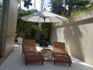 Outdoor patio with lounge chairs and umbrella