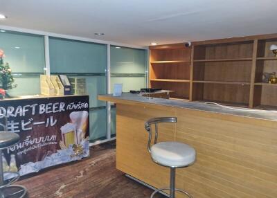 Home bar area with wooden counter and shelving