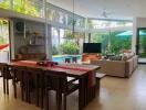 Spacious living and dining area with pool view.