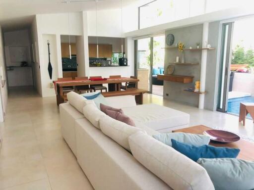 Spacious open-plan living room with sectional sofa and adjoining dining area