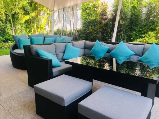 Outdoor seating area with sofas and glass table