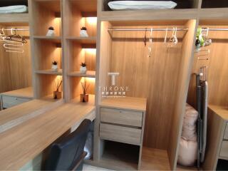 Well-organized wooden closet with shelves and hanging space