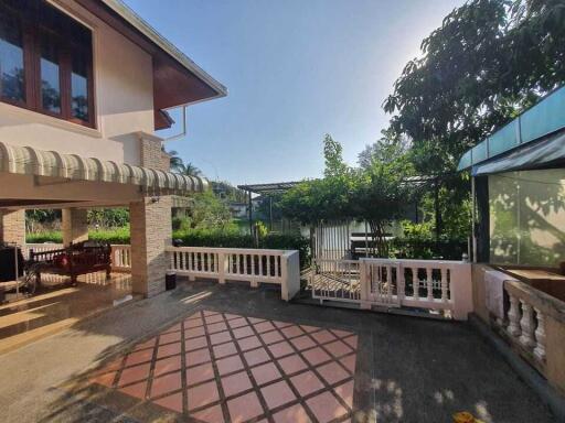 Spacious outdoor area with covered patio and garden view