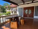 Outdoor veranda with wooden furniture and double doors