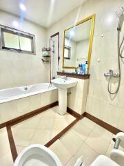 Modern bathroom with bathtub, sink, and shower