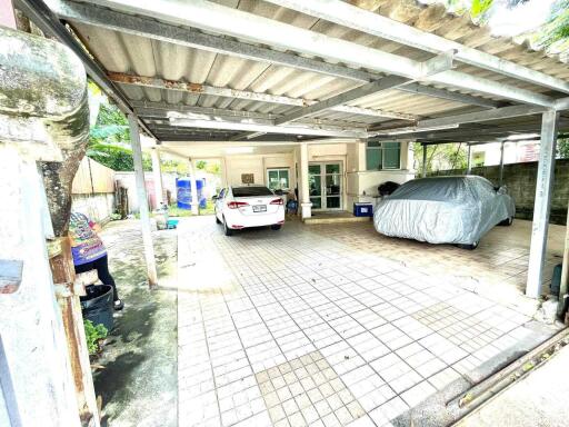 Covered garage space with cars