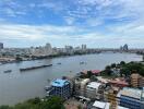 Cityscape view of riverside buildings and boats with a clear blue sky