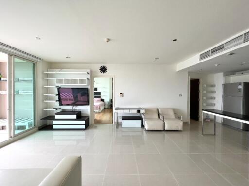 Modern living room with wall-mounted TV and white furniture