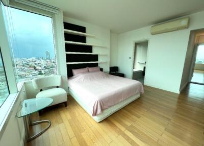 Modern bedroom with large window and city view