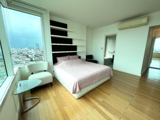 Modern bedroom with large window and city view