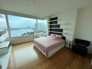 Spacious bedroom with large window and city view