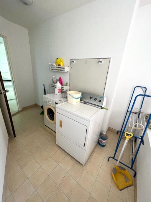 Laundry room with washing machine, dryer, and cleaning supplies