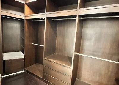 Spacious walk-in closet with wooden shelves