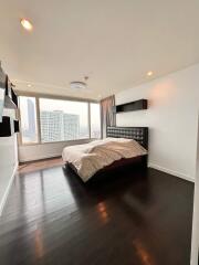 Spacious bedroom with large windows and city view