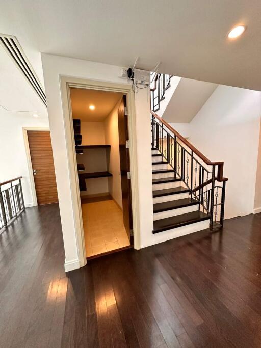 Interior hallway with staircase and open closet