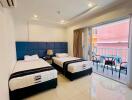 Spacious bedroom with twin beds and attached balcony