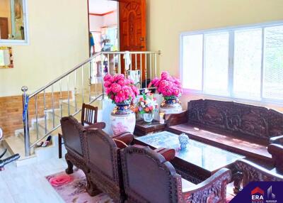 Elegant living room with wooden furniture and floral decor