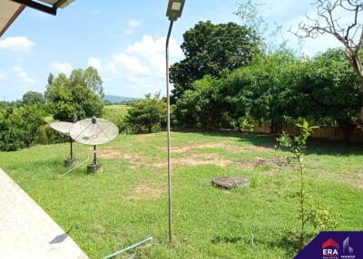 Backyard view with satellite dishes and lamppost