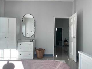 Bedroom with white furniture and a basket