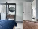 Bedroom with blue bedding and wooden furniture