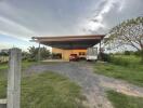 Exterior view of a house with a carport and vehicles