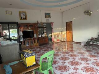 Living room with tiled floor, various furniture, and decorations.