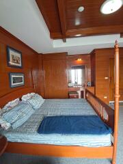 Cozy wooden-themed bedroom with bed and blue bedding