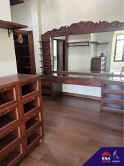 Spacious bedroom with wooden furniture and a large mirror