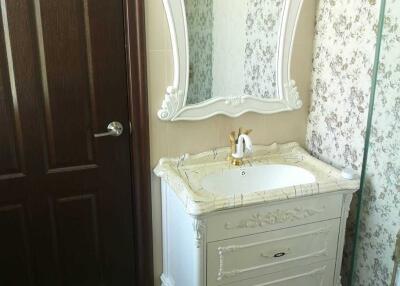 Bathroom with ornate vanity and mirror