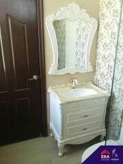 Bathroom with ornate vanity and mirror