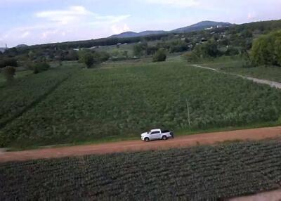 Aerial view of a countryside with a truck on a dirt road