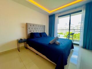 Modern bedroom with ambient lighting and balcony access