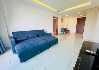 Modern living room with blue sofa and dining area