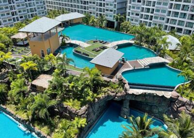 Overview of residential complex with swimming pools and lush landscape