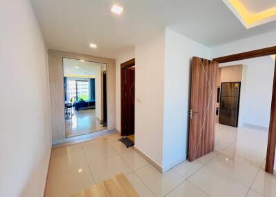 Modern hallway with open doors to living area and kitchen