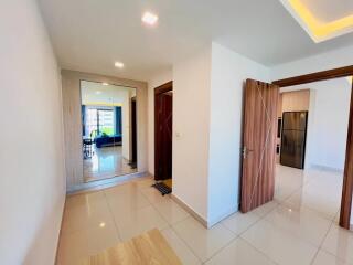 Modern hallway with open doors to living area and kitchen