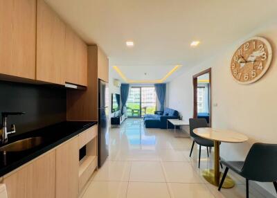 Modern living space with kitchen, dining area, and sitting area