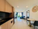 Modern living space with kitchen, dining area, and sitting area