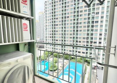 View from balcony overlooking swimming pool and adjacent building