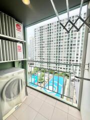 View from balcony overlooking swimming pool and adjacent building