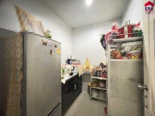 Small kitchen with refrigerator and storage shelves