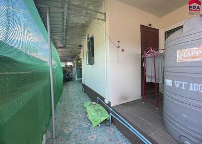 Outdoor corridor with water tank and storage sacks