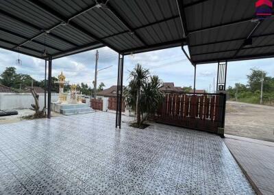 Covered outdoor area with tiled flooring and garden