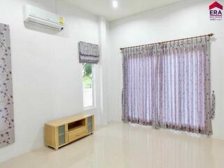 Living room with curtains and air conditioner