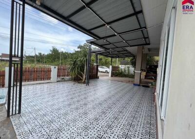 Spacious covered outdoor area with patterned flooring