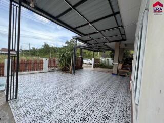 Spacious covered outdoor area with patterned flooring