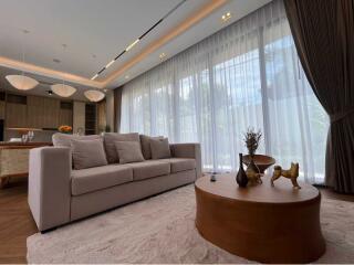 Elegant living room with a large window and modern furniture.