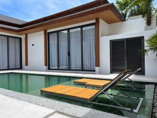 Modern outdoor area with pool and lounge chairs